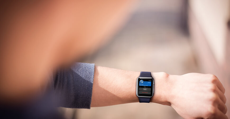 A person wearing an apple watch with the time displayed.