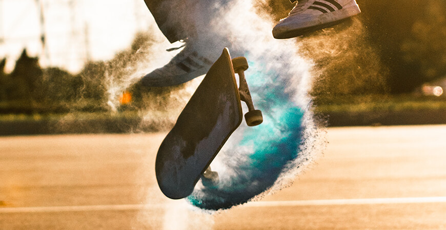 A person jumping in the air with a skateboard.