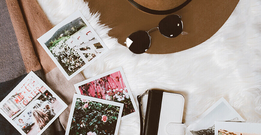 A woman 's purse and sunglasses are sitting on the table.